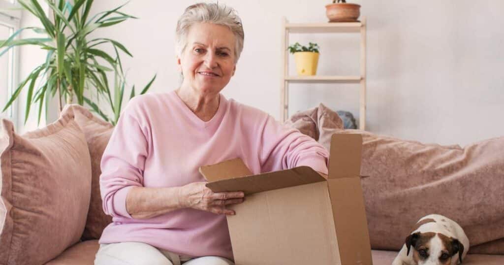Planning for a successful move to senior living Woman with moving box